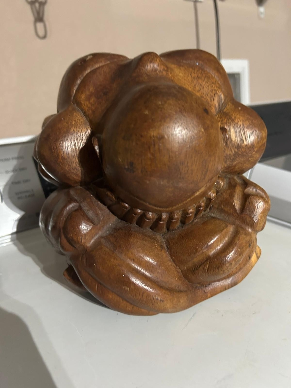 hand-carved wooden Weeping Buddha sculpture, also known as Orang Malu or the shy